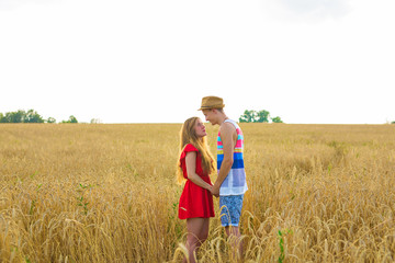 portrait of romantic couple embraces in the field