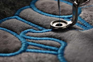 embroidery and application with embroidery machine - macro of progress satin stitch - background...