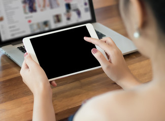 woman of business  hand working on laptop computer on wooden desk Laptop with blank screen on table.