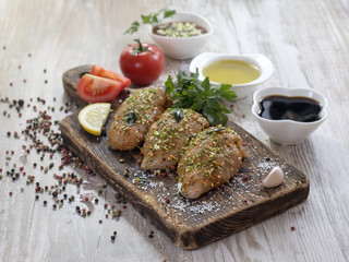 Chicken fillet in marinade on a wooden board. 