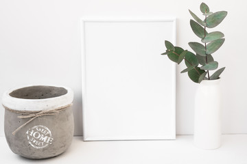White background frame mockup, green eucalyptus in ceramic vase, cement pot, styled image for social media, product marketing