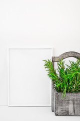 Frame mockup on white background, fresh green rosemary in vintage wood box, Provence style, styled image for blogging, social media
