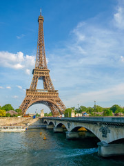 Eiffel Tower and bridge over river in Paris
