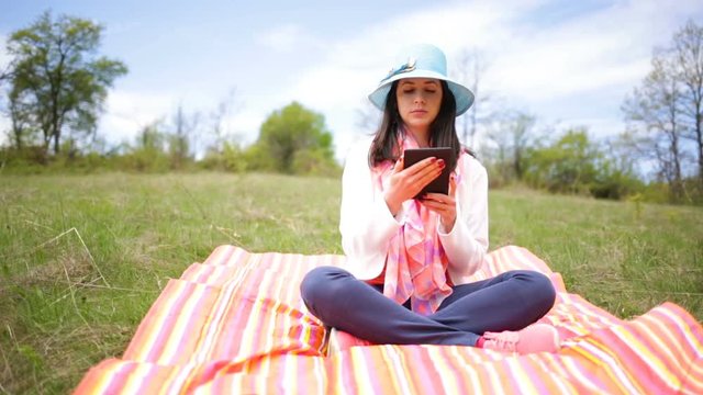 Attractive smiling young woman with e-book/tablet. Slide slider