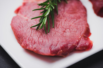 Raw beef meat sliced on a plate
