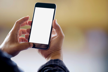 Man holding smart phone with blurred background.  For Graphic display montage.