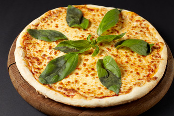 Hot pizza Margarita on a rustic wooden table.