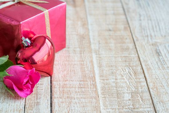  valentine`s day with roses and gift on wooden