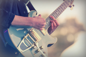 Close up of man playing a guitar