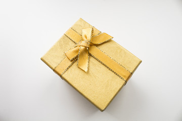 Yellow gift box closeup on white background