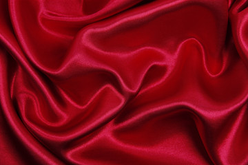 Smooth elegant red silk or satin luxury cloth texture as abstract background. Luxurious valentines day background design