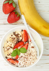 Traditional healthy Breakfast. Natural yogurt with strawberries, banana and chocolate. Selective focus