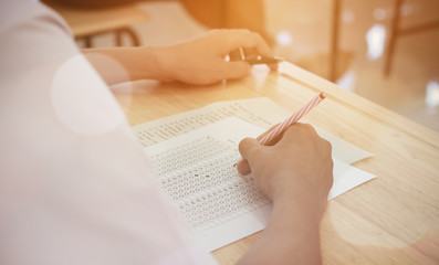 students writing test exam on paper for Admissions in high school with uniform student in School classroom of Thailand, exam student background and education concept