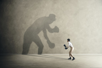 man boxing with his shadow