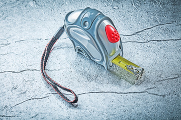 Measuring tape on metallic background construction concept
