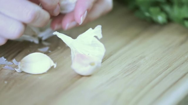 Closeup of dicing garlic on a wood cutting board