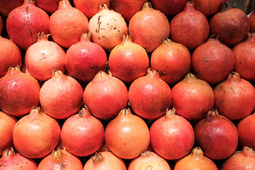 Red pomegranates in the market. Fresh fruit close up.
