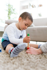 Beautiful young boy playing at home.