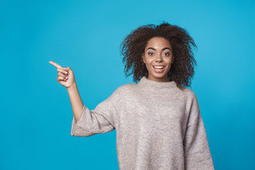 Young african woman studio portrait isolated on blue