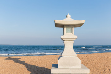Stone lantern and sand beach