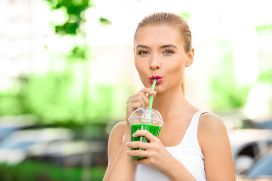 Young woman drink smoothie healthy detox outdoors