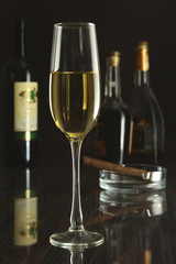 Wine glass and Bottle on a black mirror background