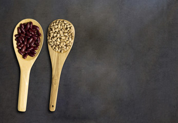 Seed on wooden spoon on dark wood, top veiw