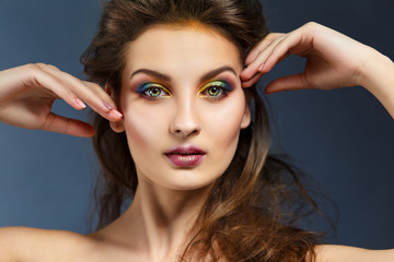 Beauty portrait of a girl with clean skin and bright evening make-up.