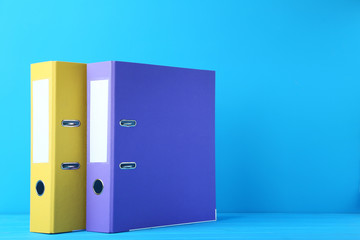 Colorful office folders on blue background