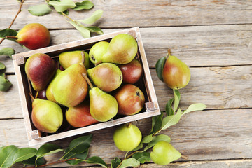 Ripe pears on grey wooden table