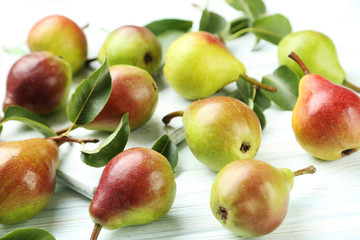 Ripe pears on white wooden table