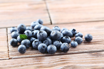 Ripe and tasty blueberries on brown wooden table