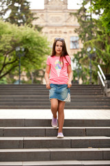 Happy stylish teenager girl in summer outfit