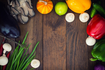 Fresh vegetables. Wooden table with food ingredients, frame style. Top view. Close-up
