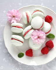 Macarons with raspberry filling and fresh raspberries