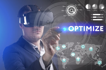 Business, Technology, Internet and network concept. Young businessman working in virtual reality glasses sees the inscription: Optimize