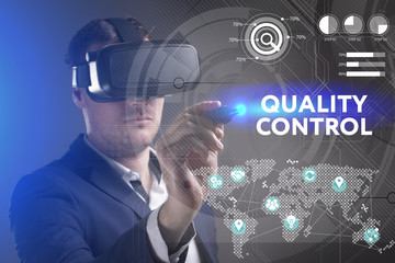Business, Technology, Internet and network concept. Young businessman working in virtual reality glasses sees the inscription: Quality control