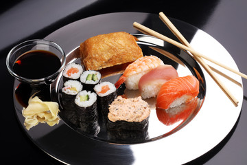 close up of sashimi sushi set with chopsticks and soy - sushi roll with salmon and sushi roll,...