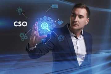 Business, Technology, Internet and network concept. Young businessman working on a virtual screen of the future and sees the inscription: CSO
