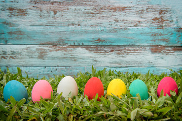 Easter eggs and in green grass. Festive decoration.