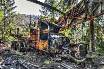 Fototapeta na wymiar Forgotten truck wreck in an abandoned quarry