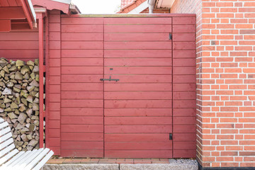 Rote Holztür in einem Garten eines Hauses