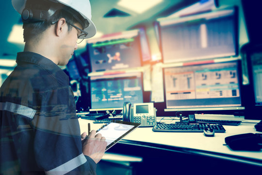 Double exposure of  Engineer or Technician man in working shirt  working with tablet in control room of oil and gas platform or plant industrial for monitor process, business and industry concept