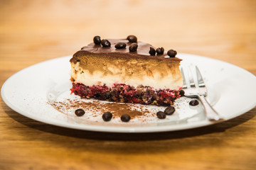 Delicious sweet baked cake with coffee beans and fruit