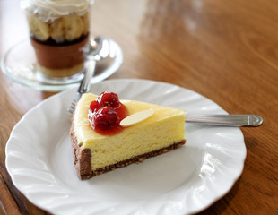 Slice of New York Cheesecake with banoffee  on wooden table.