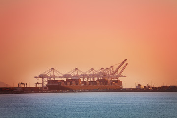Crane loading containers on barge, Long Beach, USA