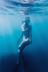 Beautiful woman snorkeling underwater.