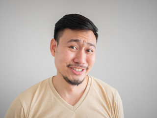 Headshot of funny guilty Asian man.