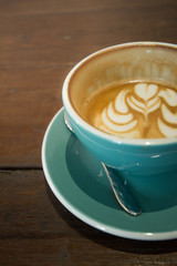 Latte art on wooden table 