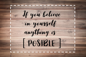 If you believe in yourself anything is POSSIBLE words on brown wooden wall.